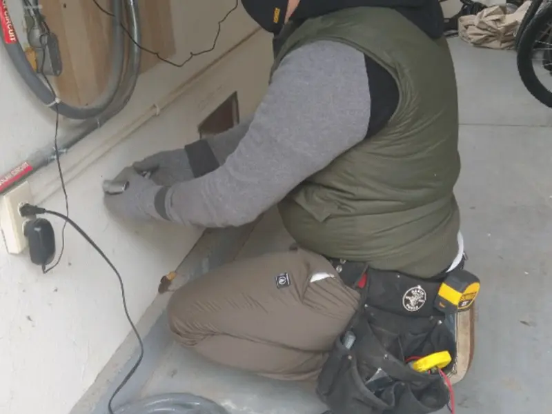 Electrician performing outlet wiring in a Cayce garage
